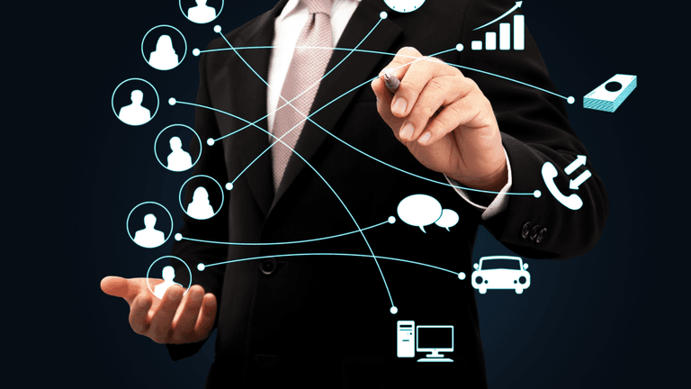Businessman in a suit interacting with digital connectivity graphics and icons