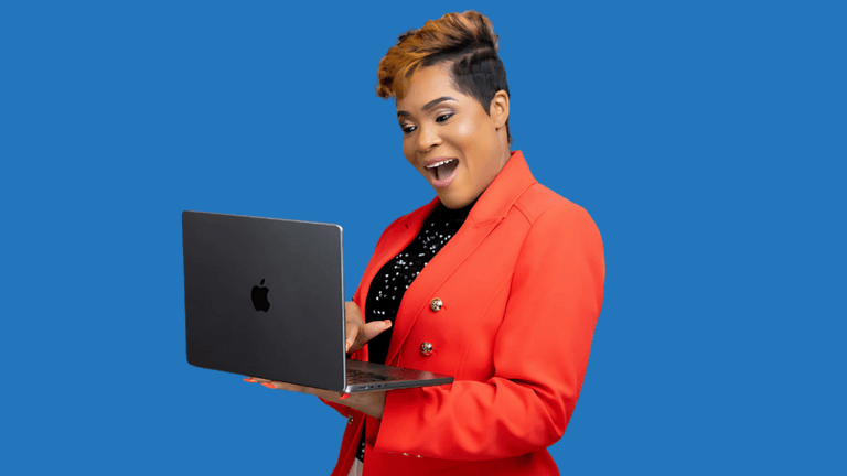 Woman in a red blazer holding a laptop, smiling against a blue background