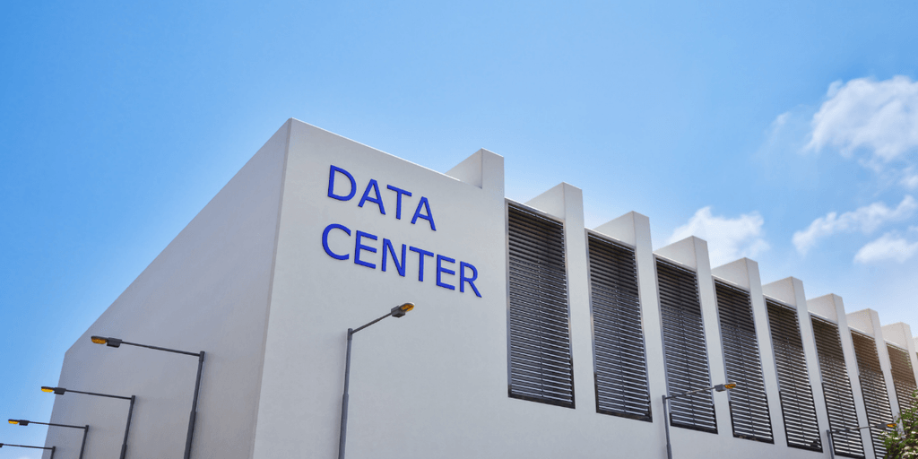 Modern data center building with blue signage and clear blue sky