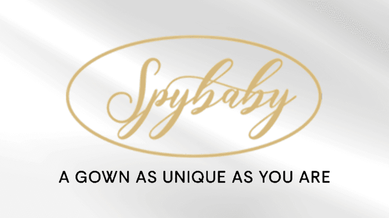 Logo for Spybaby featuring elegant gold script with tagline about unique gowns