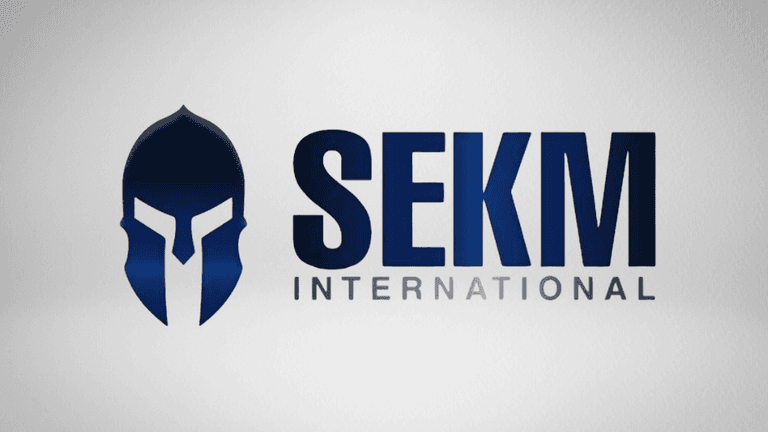 Logo of SEKM International featuring a stylized spartan helmet and bold typography
