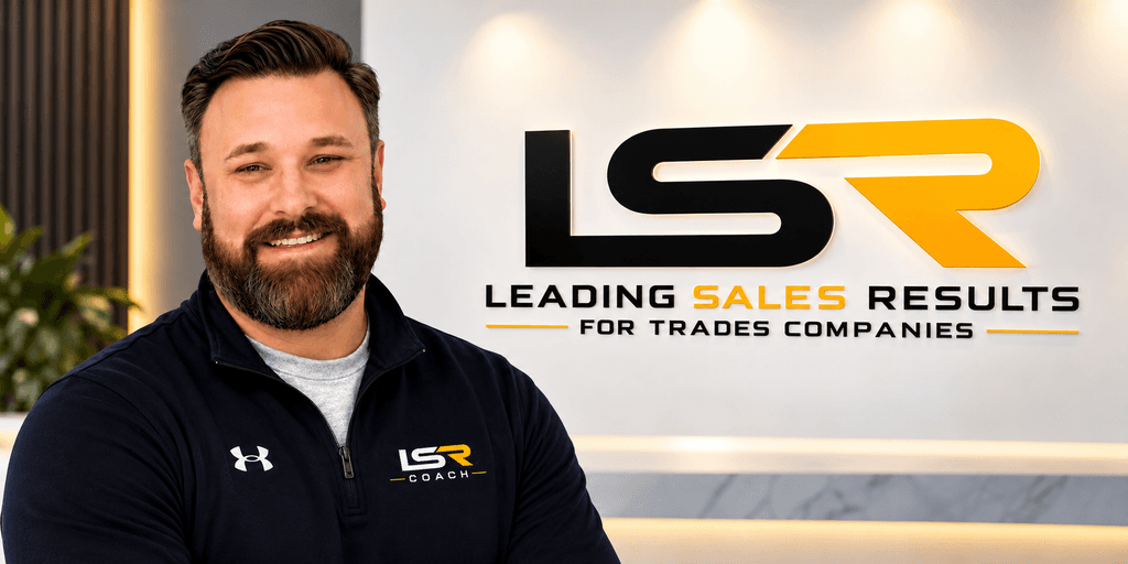 Man smiling in front of a branded wall displaying "LSR Coach" and company slogan