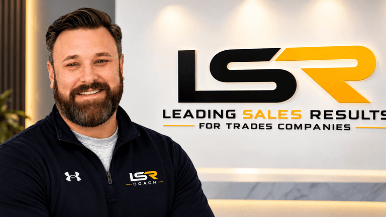 Man smiling in front of a branded wall displaying "LSR Coach" and company slogan