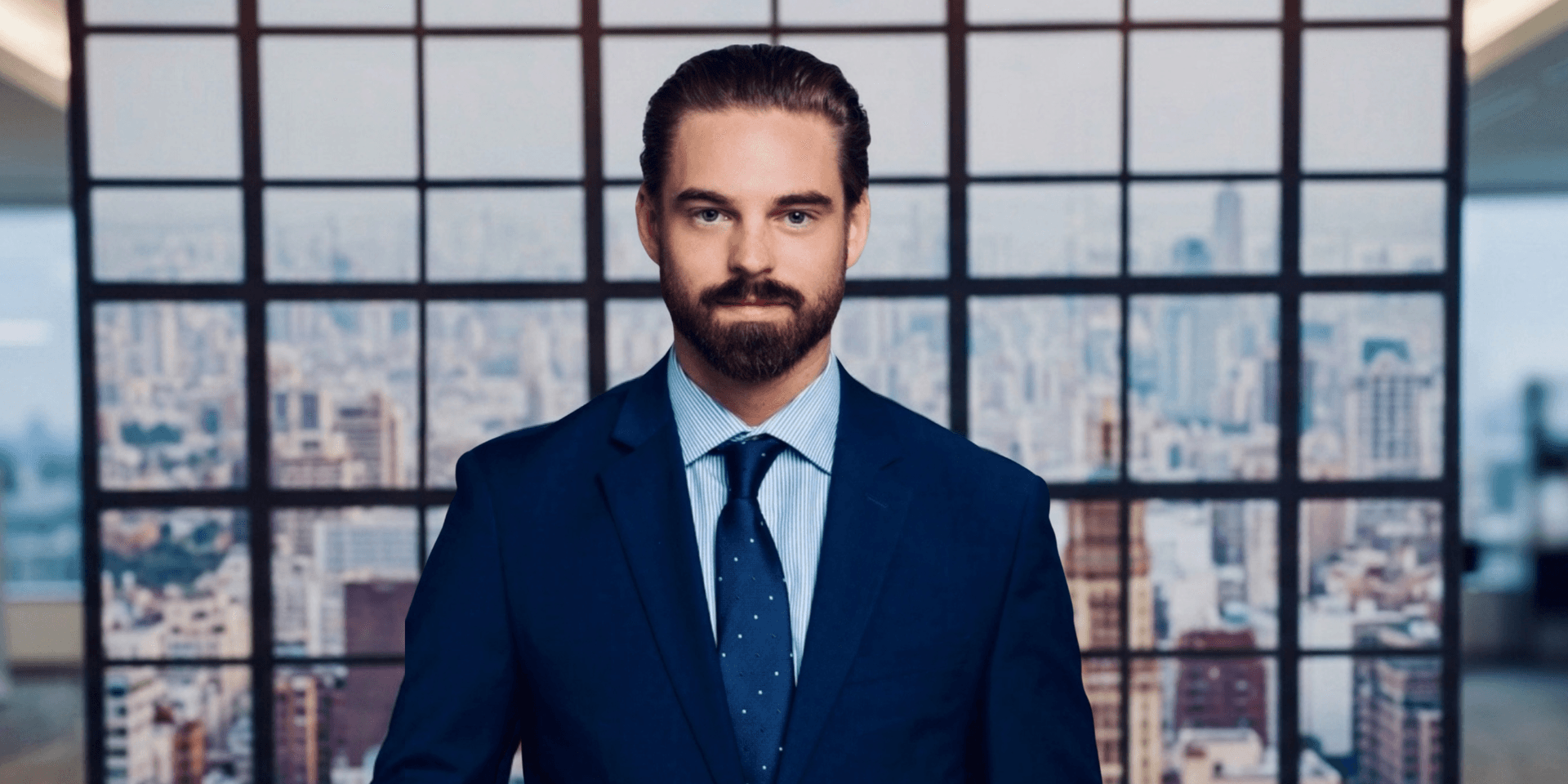 A man in a suit stands confidently against a city skyline backdrop