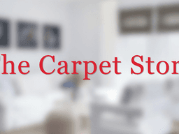 Blurred interior of a living room with the text "The Carpet Store" superimposed