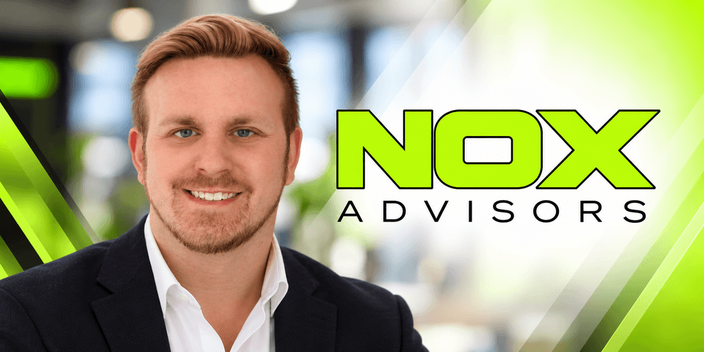 Smiling man in business attire beside logo for NOX Advisors in a modern setting