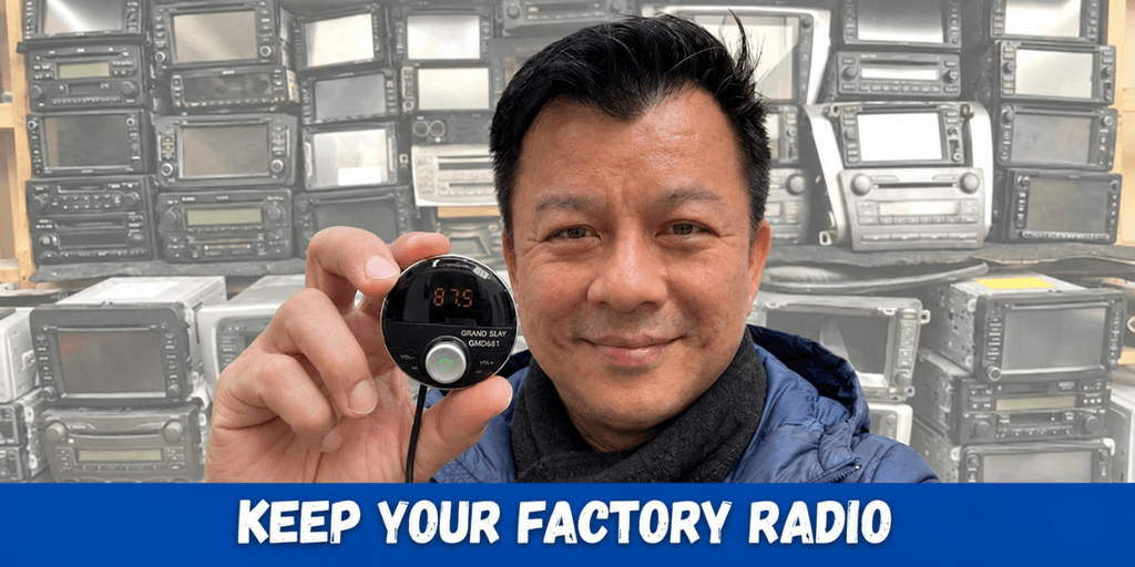 Man holding a device in front of a wall of old radios