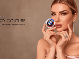 A woman holds a colorful crystal design, showcasing elegant jewelry against a neutral background