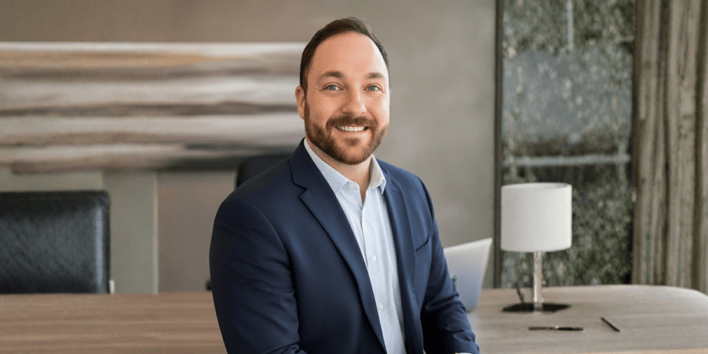 Professional headshot of Sean Barrite in a business setting, reflecting leadership and success.