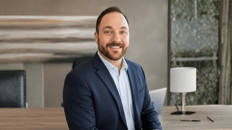 Professional headshot of Sean Barrite in a business setting, reflecting leadership and success.