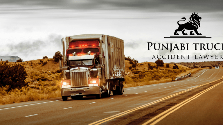 Truck driving on a highway with Punjabi Truck Accident Lawyer logo, symbolizing advocacy for justice in truck accident cases.