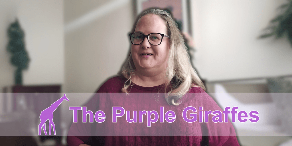 "A woman smiling and standing in front of a blurred background, wearing a maroon sweater and glasses, with the logo of 'The Purple Giraffes' in purple text and a giraffe icon on the left."