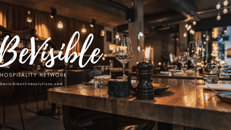 Elegant restaurant setting with candles and wine glasses, reflecting the warmth and hospitality of BeVisible Online Solutions.