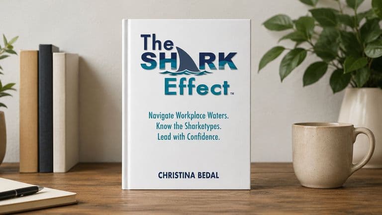 Cover of The Shark Effect by Christina Bedal displayed on a desk beside books, plants, and a coffee mug.