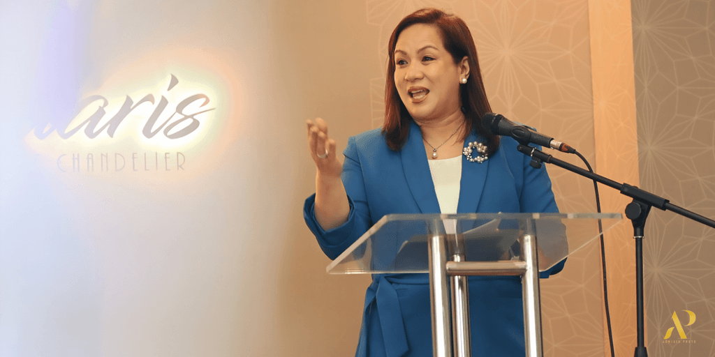 Sharon P. Fabian speaking at a Themes & Motifs wedding industry event.