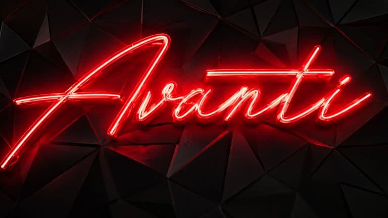 Red neon Avanti sign mounted on a black geometric wall.