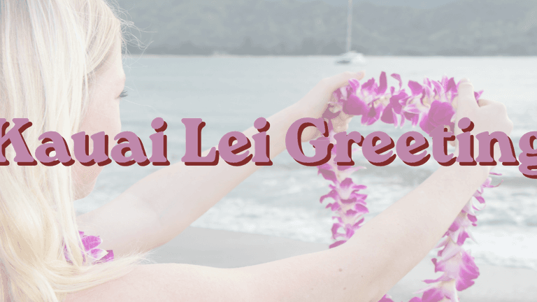 Young woman holding a purple lei on a Kauaʻi beach, welcoming visitors with aloha.