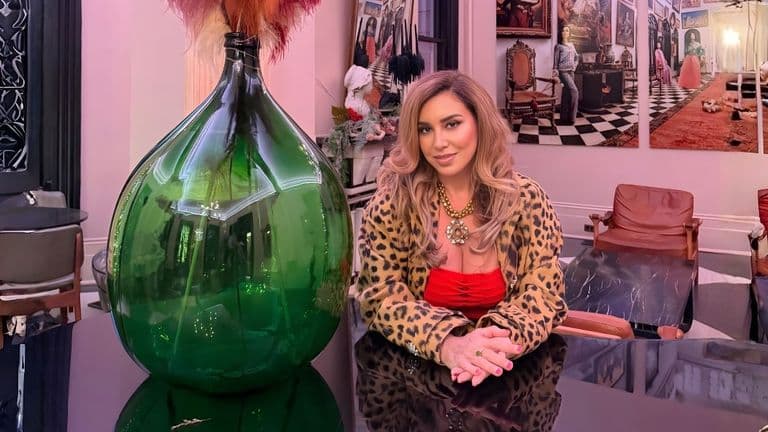 Maria Micha, a spiritual psychotherapist and healer, surrounded by elegant decor, symbolizing her transformative work.