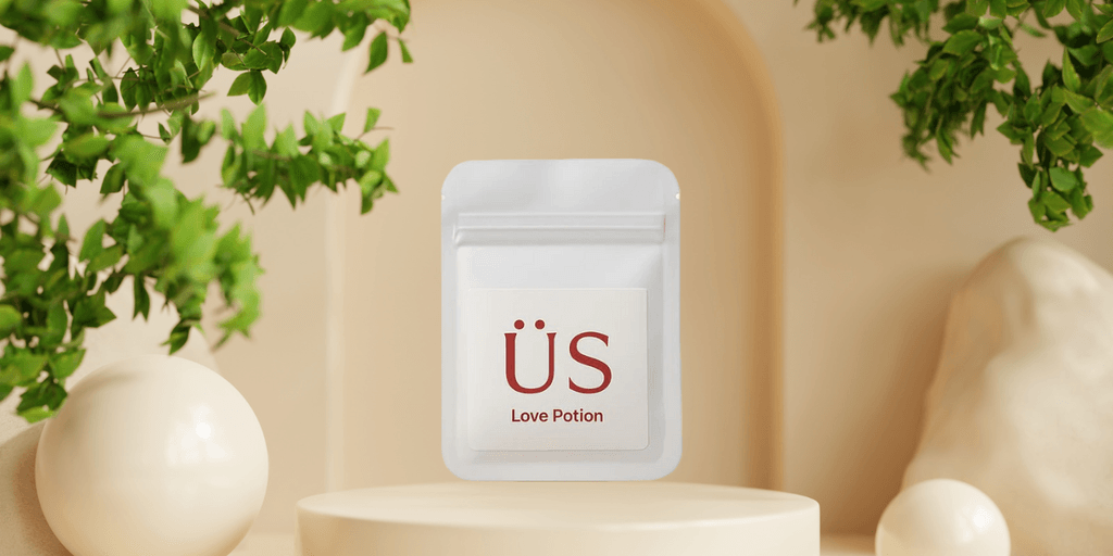 Minimalist pouch labeled "ÜS Love Potion" displayed on a pedestal, reflecting a luxury wellness brand's empowerment philosophy.