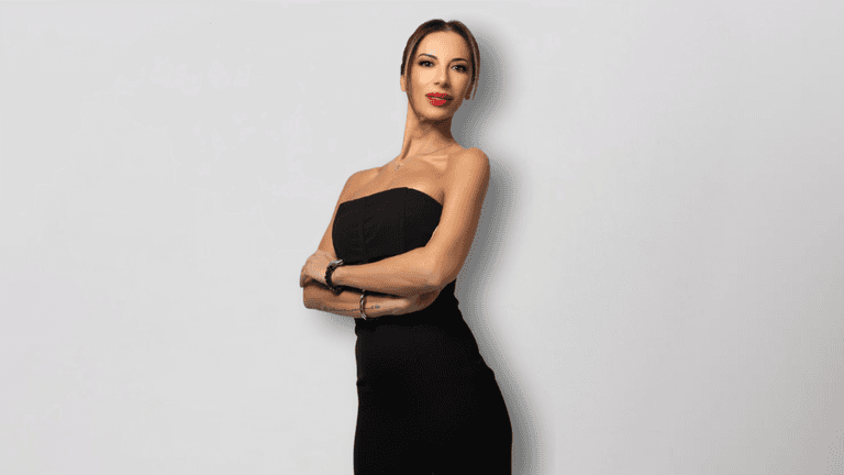 Valeria Petza poses confidently in a black strapless dress, showcasing elegance and professionalism.