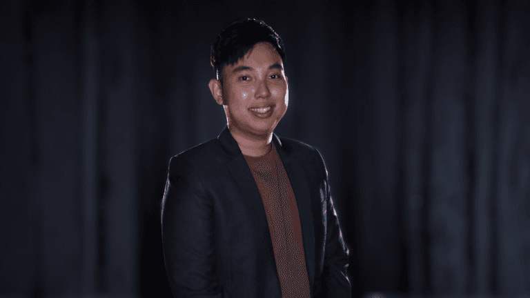 Chan Ming Yang, founder of M&A Education, standing confidently in a professional setting.
