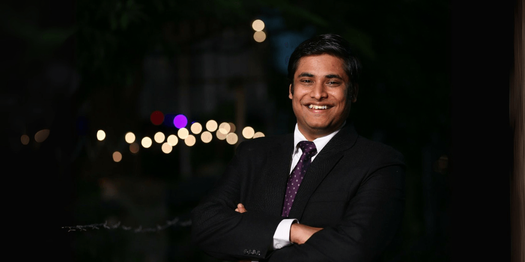 Vivek Rangabhashyam smiling in a suit, representing his inspiring journey of resilience, entrepreneurship, and community impact.