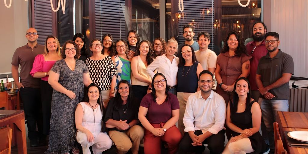 A joyful group of ENBER University faculty members posing for a photo in a restaurant, celebrating their top ranking in scientific production.