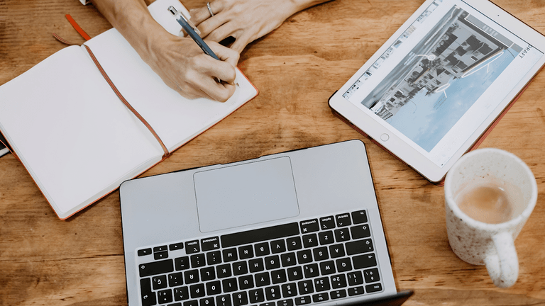 Person typing on a laptop, highlighting the need for clear branding and optimized digital content for trades.