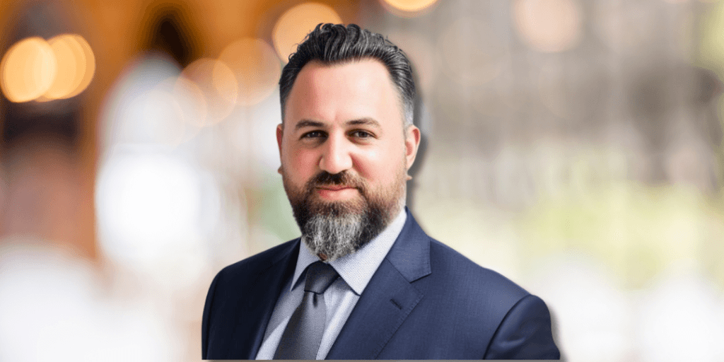 Tamir Leo Konortov, founder of KAL Solutions Group, in a suit, representing global tech outsourcing excellence.