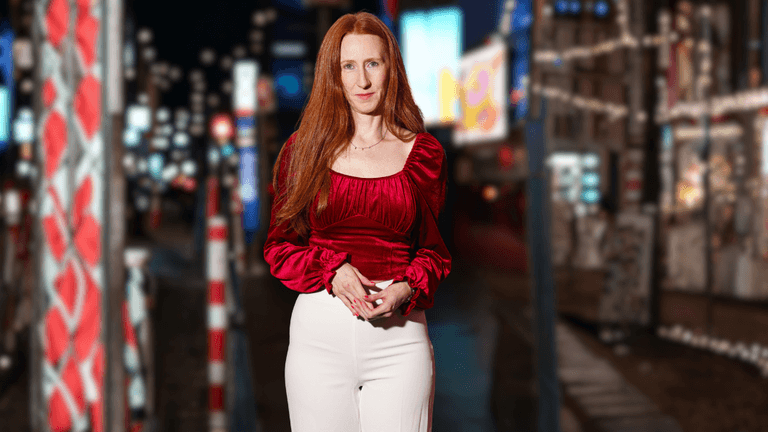 Monica Trombley, creative professional and entertainment lawyer, stands confidently in a vibrant city setting.
