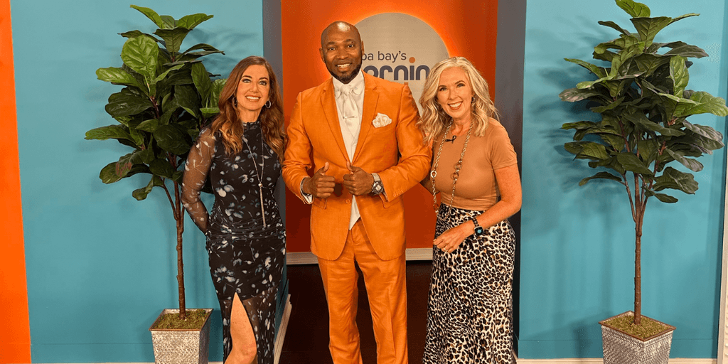 Rick E. Cutts posing with two television hosts on the Tampa Bay's Morning Blend set.