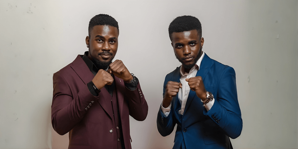 Miraculous and Miracle Ighalo, founders of The Ighalos Systems, posing confidently in suits.