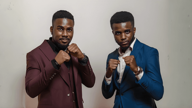 Miraculous and Miracle Ighalo, founders of The Ighalos Systems, posing confidently in suits.