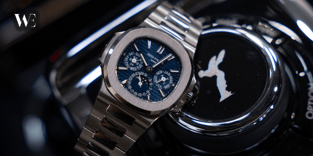 Patek Philippe luxury watch displayed beside a Rolls-Royce emblem with the Watches Established logo.