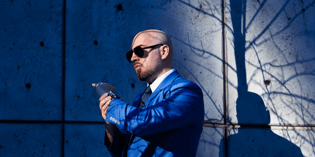 Liam Legault, founder and creative director of Liam Legault Design, wearing a blue suit and sunglasses.