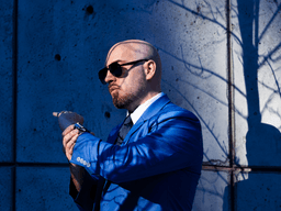 Liam Legault, founder and creative director of Liam Legault Design, wearing a blue suit and sunglasses.
