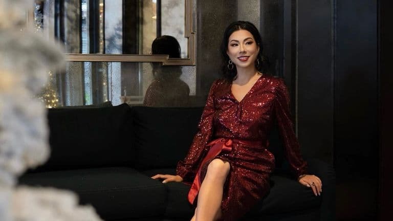 Susye Weng-Reeder in a red sequin dress seated in a luxury hotel suite, featured on the cover of CEO Times as a Google Verified Internet Personality and global digital architect.