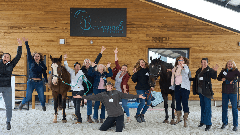 Tracey Evans, founder of Dreamwinds, guiding a corporate team through an equine-assisted leadership session, emphasizing communication, collaboration, and authentic leadership development.