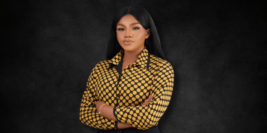 "Portrait of a confident woman in a bold polka dot shirt, standing with arms crossed against a dark background, exuding strength and professionalism."