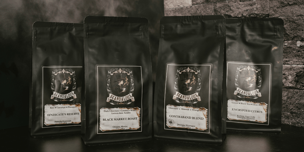 Four Scandalous Coffee bags featuring unique roast names and dark, elegant packaging.