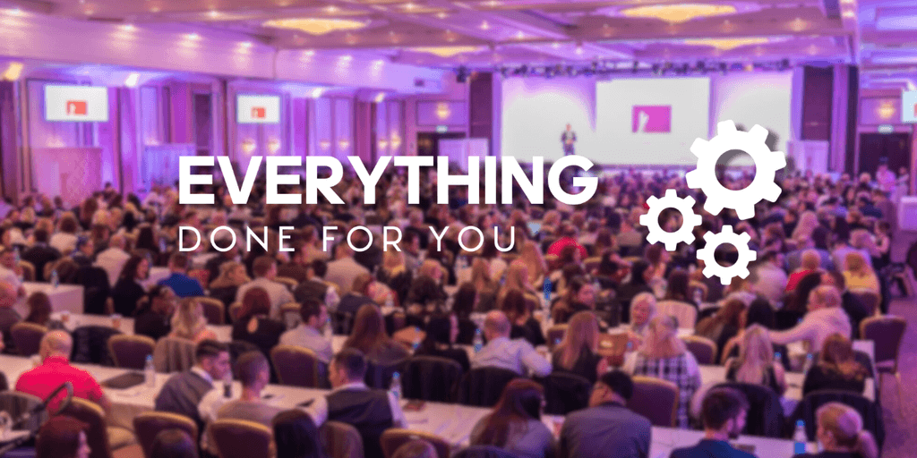 A conference or event with a large audience sitting at tables, with a speaker on stage. The words 'Everything Done For You' and gear icons are overlaid on the image.