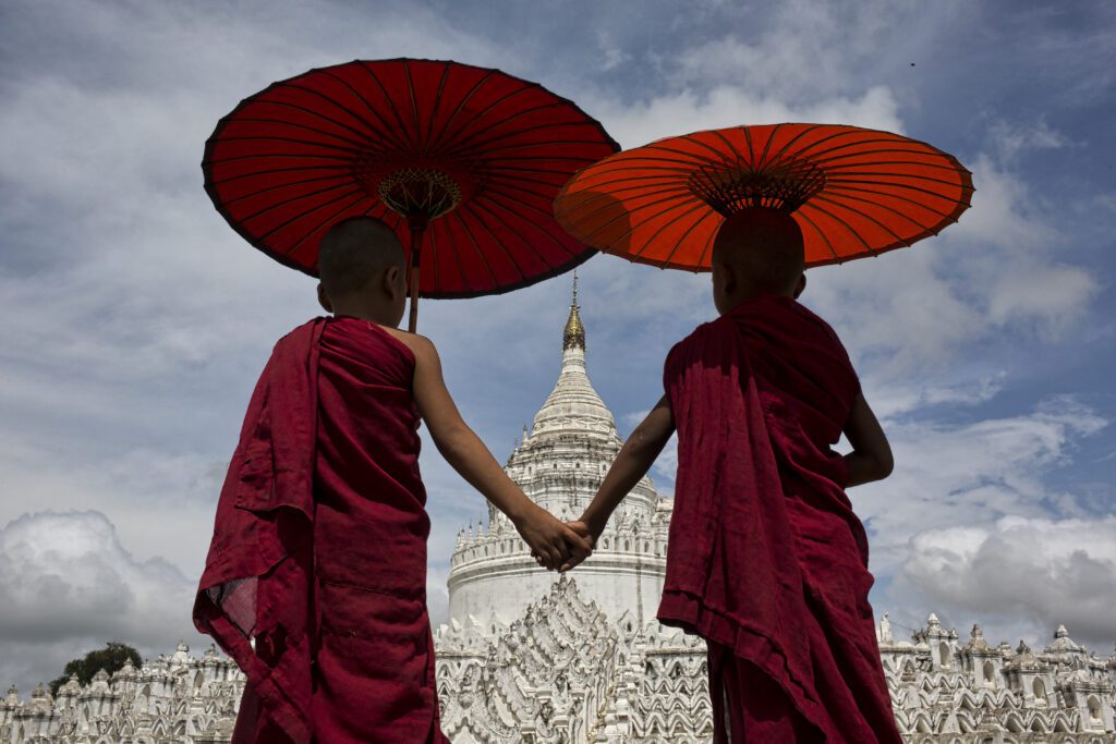 Boys holding hands at temple