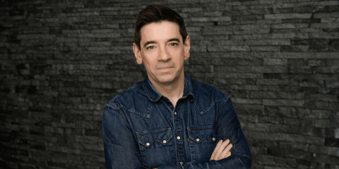 Image of Damian Qualter, founder of AutomateToGrow, standing confidently against a stone wall.