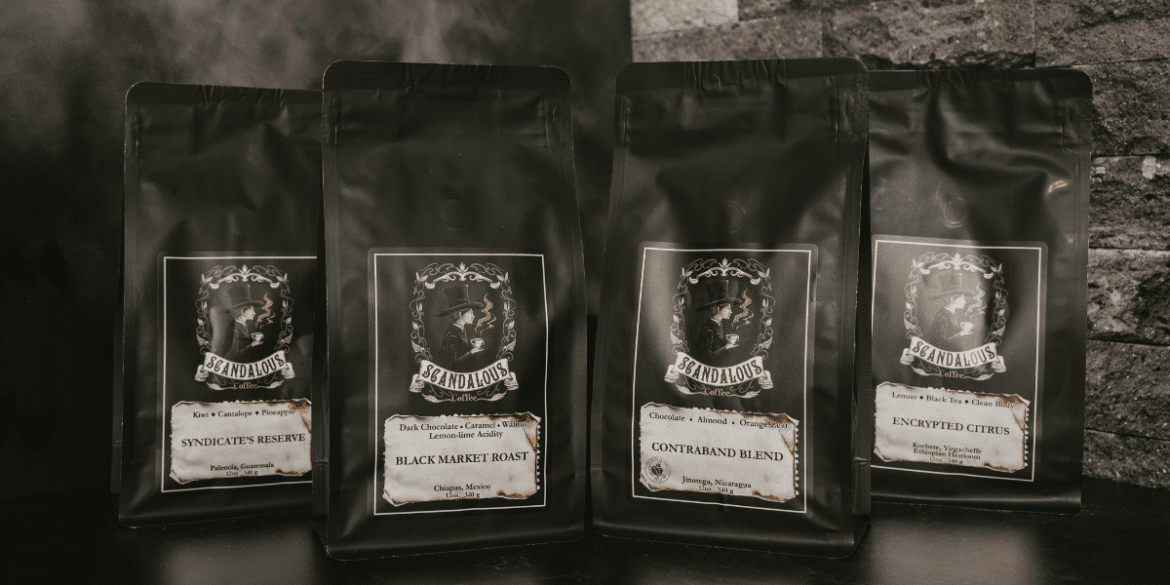 Four Scandalous Coffee bags featuring unique roast names and dark, elegant packaging.