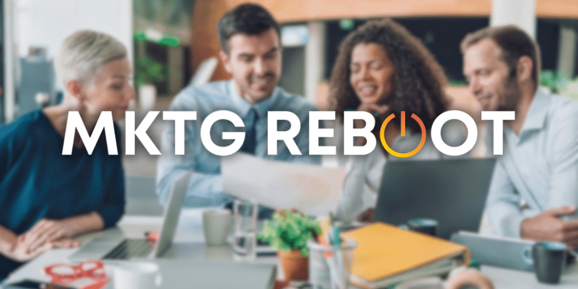 A diverse group of professionals collaborates around a table, discussing strategies to optimize marketing efforts, reflecting MKTG Reboot’s focus on structured, growth-driven marketing solutions.