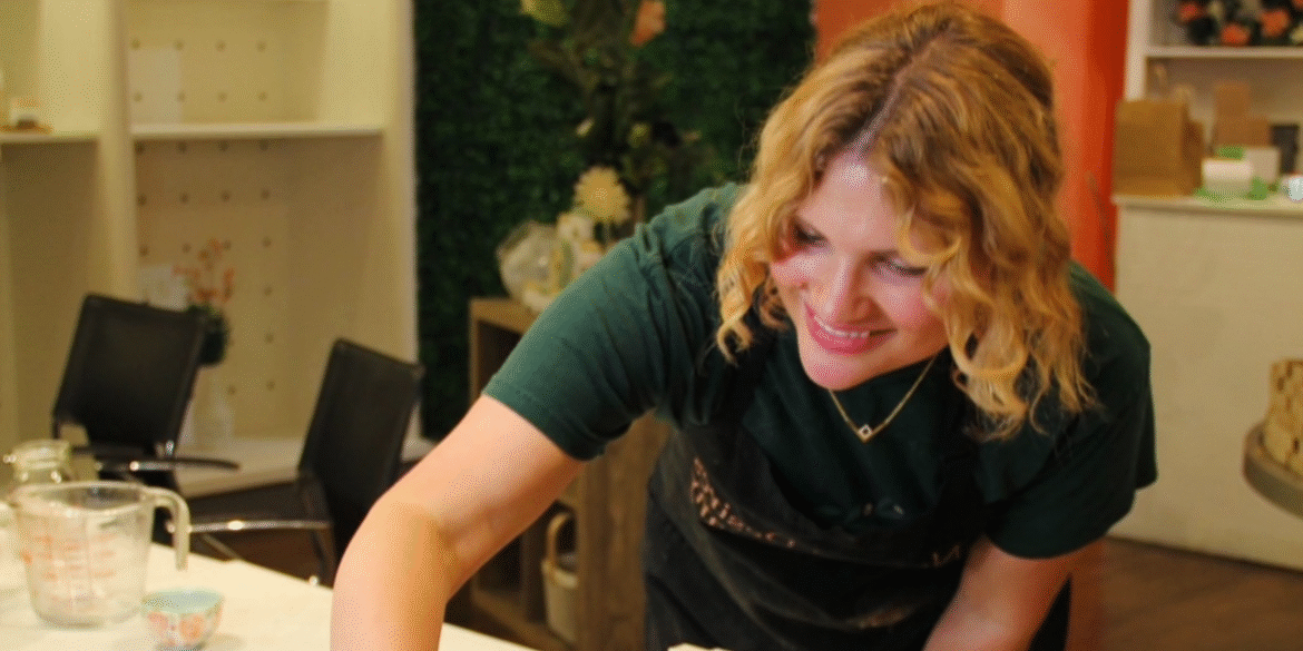 Nicole Boshell, founder of Natural Desires Soap Company, smiling while crafting natural soaps in her workshop, promoting toxin-free skincare.