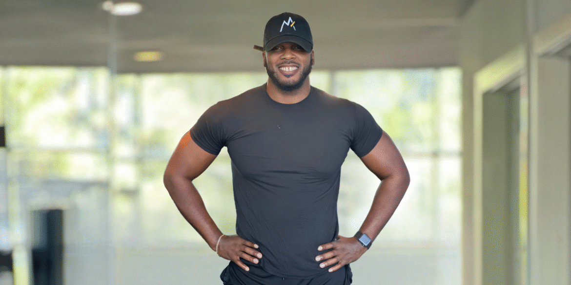 Chaz Ferguson standing confidently, showcasing his fitness and strength, embodying his holistic approach to personal transformation and empowerment.