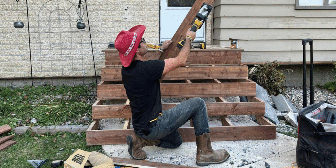 Carpenter Johnny builds wooden deck stairs in Winnipeg, showcasing craftsmanship and dedication to quality construction.