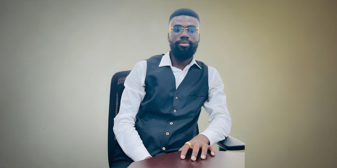 Benjamin Sarpong, founder of Lofty Auto Exports, confidently poses at his desk, embodying success from humble beginnings.