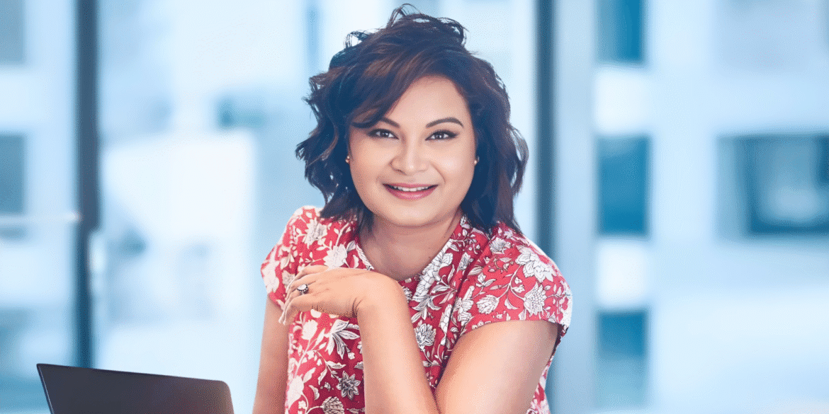 Kelly Markey smiling in office, founder of Beacon of Hope and Markey Writing Academy, empowering global changemakers through literature.